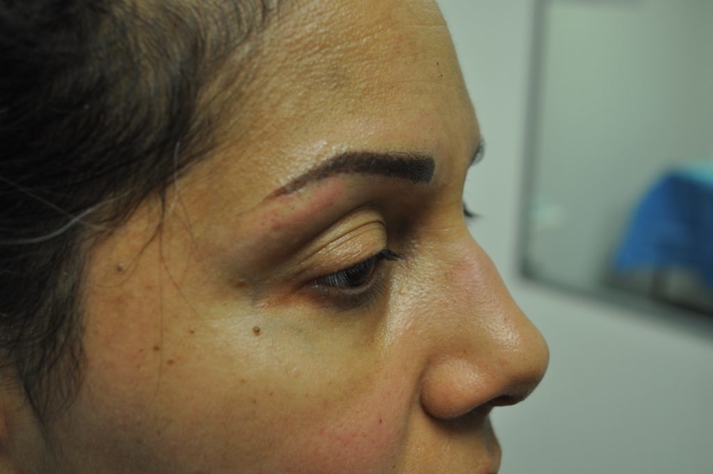 Close-up of a woman's face showing eyebrow details.
